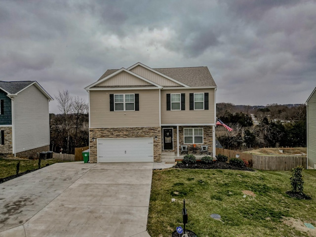 view of front of house with central AC, a garage, and a front lawn