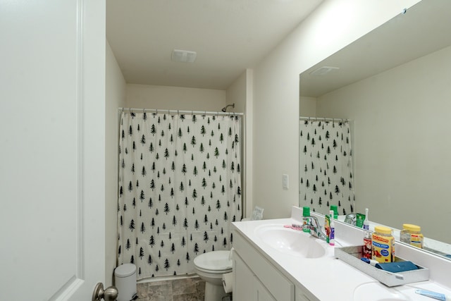 bathroom featuring vanity, toilet, and curtained shower