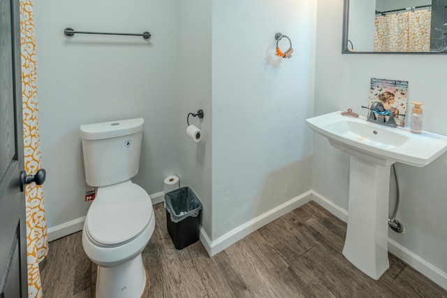 bathroom featuring toilet and hardwood / wood-style flooring