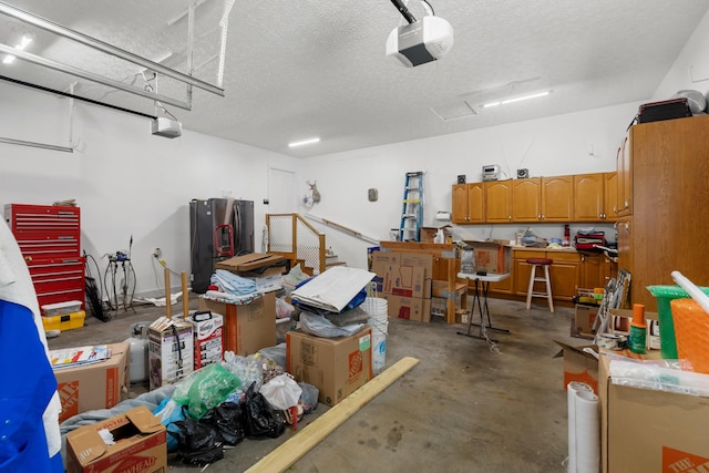 1114 Lake Ridge Dr, Dandridge, TN 37725 - garage featuring a garage door opener and stainless steel fridge with ice dispenser