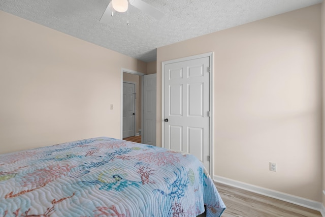 1114 Lake Ridge Dr, Dandridge, TN 37725 - bedroom with light wood finished floors, baseboards, a textured ceiling, and a ceiling fan
