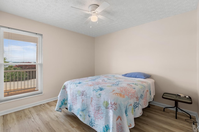 1114 Lake Ridge Dr, Dandridge, TN 37725 - bedroom featuring baseboards, wood finished floors, a textured ceiling, and ceiling fan