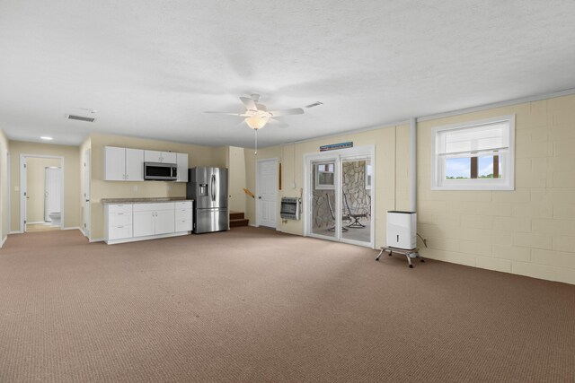 1114 Lake Ridge Dr, Dandridge, TN 37725 - unfurnished living room with heating unit, light colored carpet, a ceiling fan, and a textured ceiling