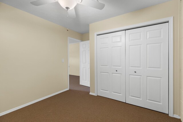1114 Lake Ridge Dr, Dandridge, TN 37725 - unfurnished bedroom with dark carpet, a closet, baseboards, and ceiling fan