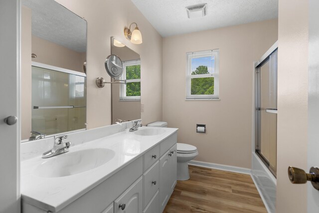 1114 Lake Ridge Dr, Dandridge, TN 37725 - bathroom featuring toilet, double vanity, wood finished floors, baseboards, and a textured ceiling