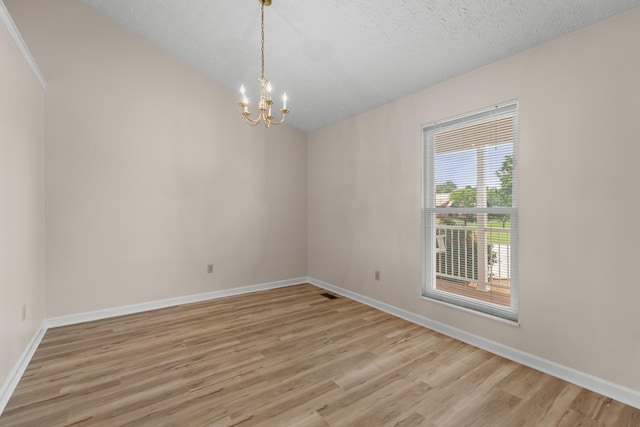 1114 Lake Ridge Dr, Dandridge, TN 37725 - empty room featuring a chandelier, light wood-style floors, baseboards, a textured ceiling, and vaulted ceiling