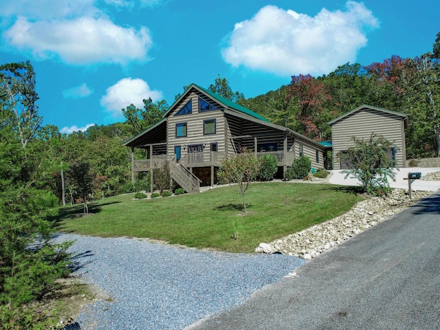 log home featuring a deck and a front lawn