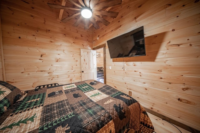 bedroom with wood walls and ceiling fan