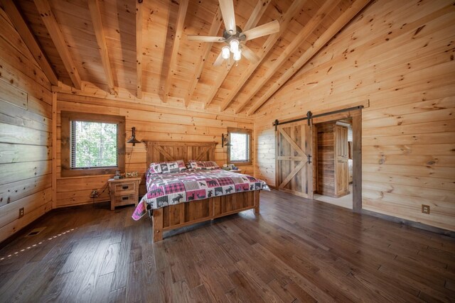 bedroom featuring a barn door, lofted ceiling with beams, wood walls, and wood ceiling