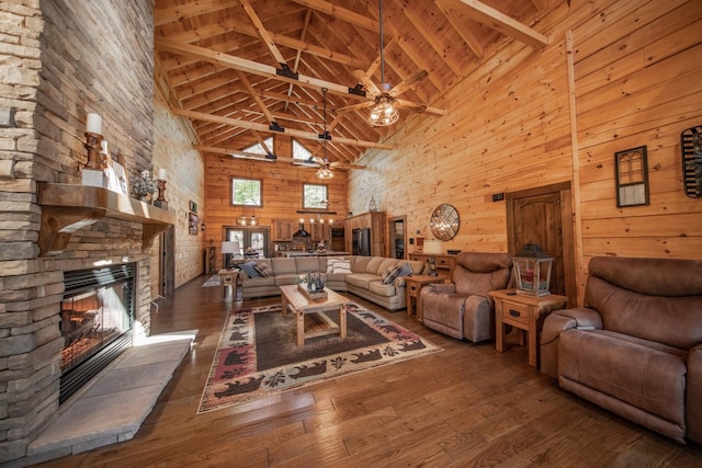 living room with beam ceiling, a fireplace, and high vaulted ceiling