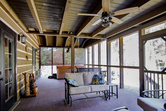 unfurnished sunroom with ceiling fan