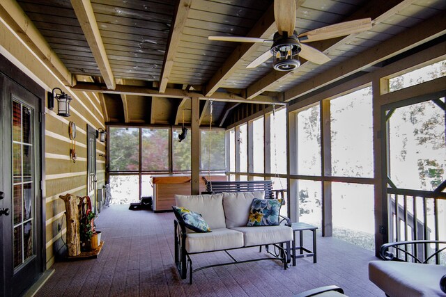 unfurnished sunroom with ceiling fan