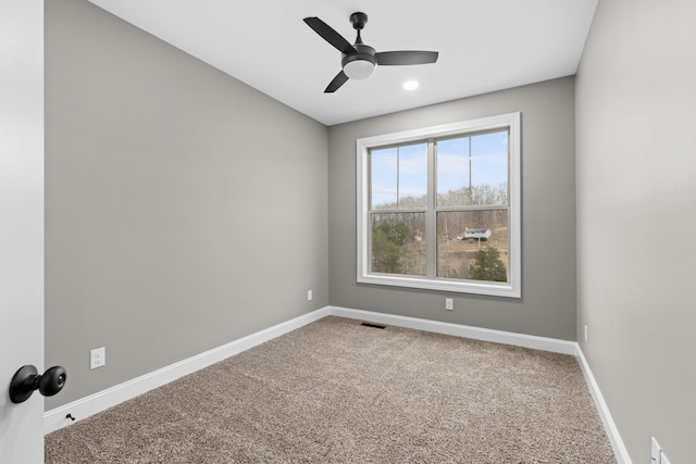 empty room with carpet flooring and ceiling fan