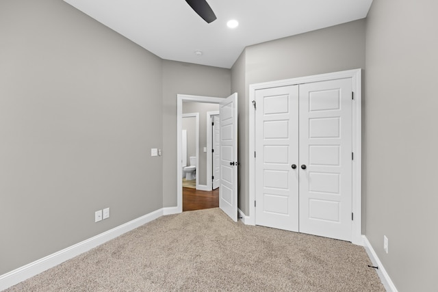 unfurnished bedroom with ceiling fan, a closet, and carpet floors