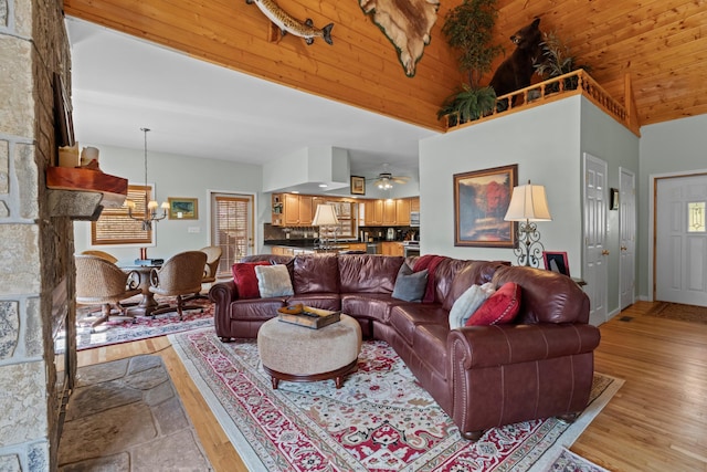 living room featuring high vaulted ceiling, light wood-style floors, wood ceiling, and a ceiling fan