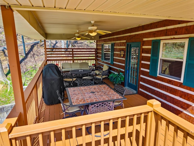 deck with a grill and ceiling fan
