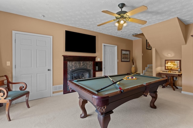 rec room with pool table, a ceiling fan, light carpet, a textured ceiling, and visible vents