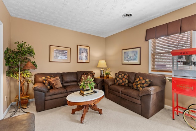 carpeted living area featuring a textured ceiling, baseboards, and visible vents