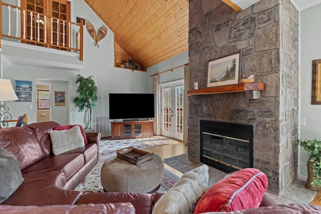 living room with high vaulted ceiling, wooden ceiling, french doors, wood finished floors, and a stone fireplace