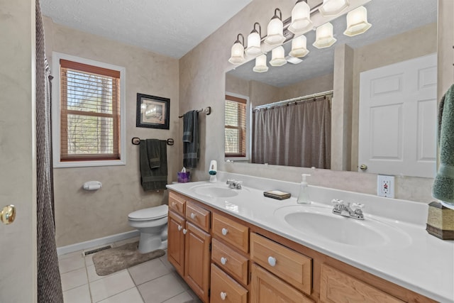 bathroom with toilet, a sink, a textured ceiling, and visible vents