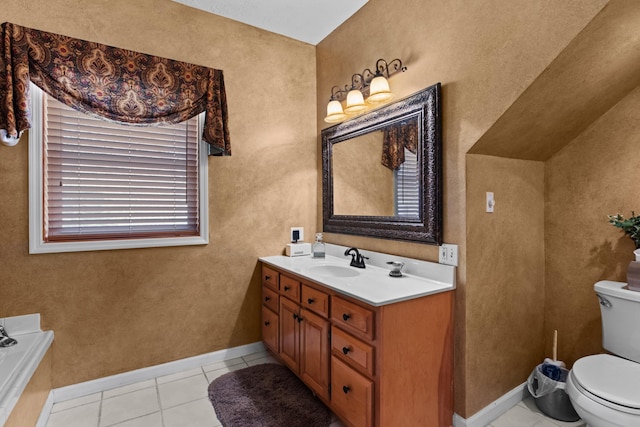 bathroom featuring a bath, baseboards, toilet, vanity, and tile patterned flooring