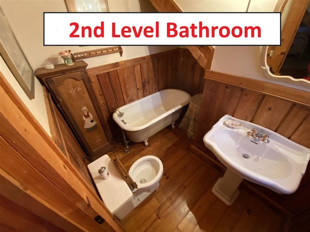2965 Round Mountain Rd, Del Rio, TN 37727 - bathroom with a freestanding tub, wood finished floors, wood walls, and wainscoting