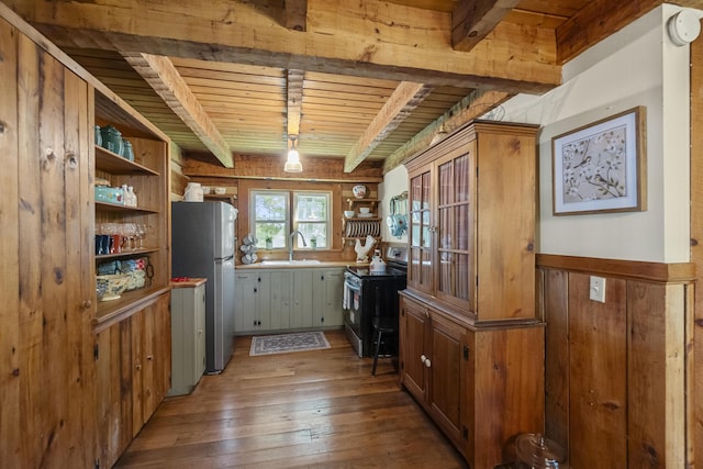 kitchen with wood ceiling, beamed ceiling, hardwood / wood-style floors, black electric range oven, and stainless steel refrigerator