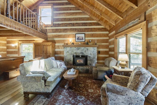 living room with wood ceiling, beam ceiling, high vaulted ceiling, a wood stove, and wood walls