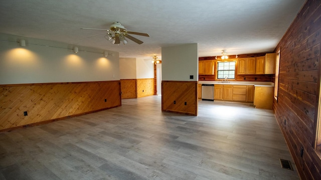 158 Delph Ln, Mooresburg, TN 37811 - kitchen with dishwasher, wood walls, open floor plan, a wainscoted wall, and a ceiling fan