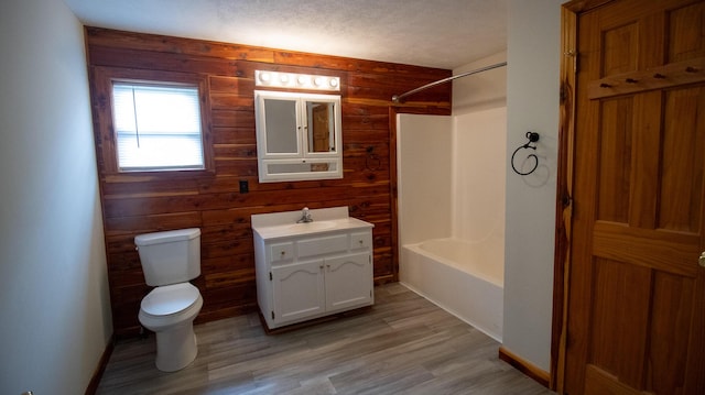 158 Delph Ln, Mooresburg, TN 37811 - bathroom with wood walls, vanity, bathing tub / shower combination, and wood finished floors