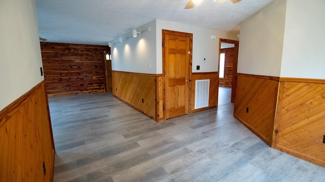 158 Delph Ln, Mooresburg, TN 37811 - empty room with wooden walls, a wainscoted wall, ceiling fan, and wood finished floors