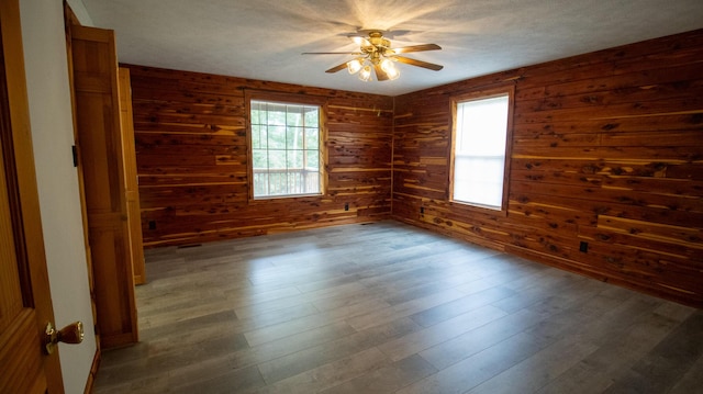 158 Delph Ln, Mooresburg, TN 37811 - spare room with plenty of natural light, ceiling fan, wooden walls, and dark wood-style flooring