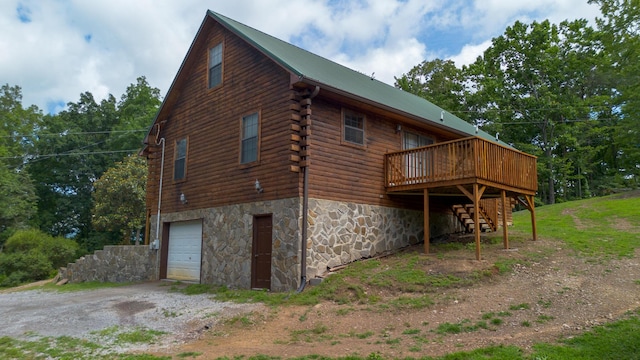 158 Delph Ln, Mooresburg, TN 37811 - view of home's exterior with driveway, stairs, an attached garage, log siding, and a wooden deck