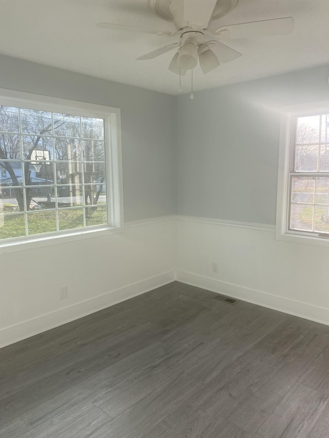 spare room with ceiling fan and dark hardwood / wood-style floors