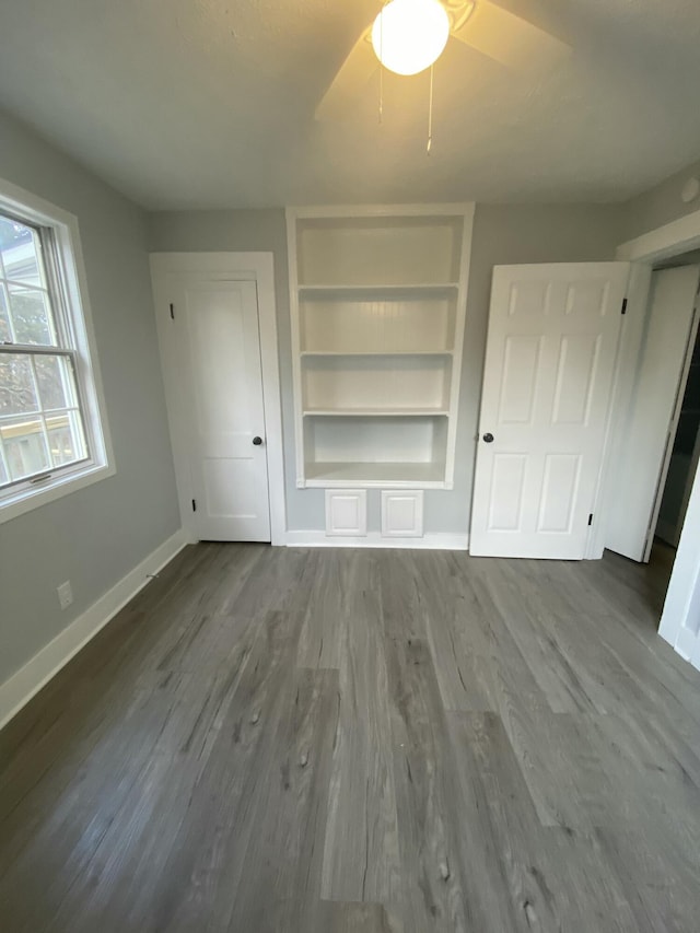 unfurnished bedroom with ceiling fan and wood-type flooring