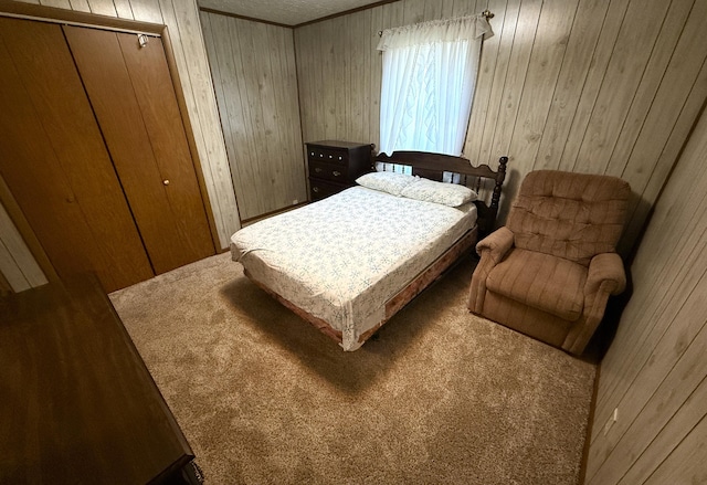 bedroom with wood walls, crown molding, and carpet floors