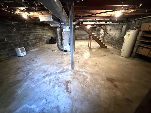 basement featuring heating unit and water heater