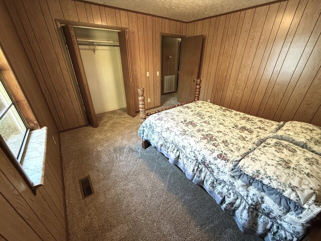 bedroom featuring carpet flooring, a textured ceiling, and a closet