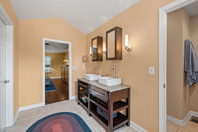 117 Tahlequah Ln, Loudon, TN 37774 - full bathroom featuring double vanity, tile patterned floors, vaulted ceiling, and baseboards