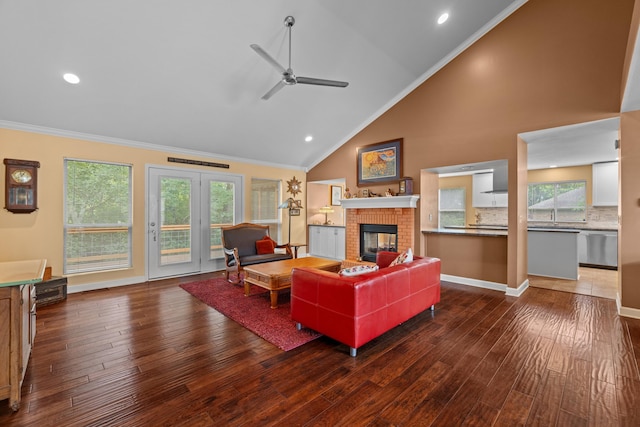 117 Tahlequah Ln, Loudon, TN 37774 - living area with ornamental molding, a ceiling fan, a brick fireplace, wood finished floors, and high vaulted ceiling