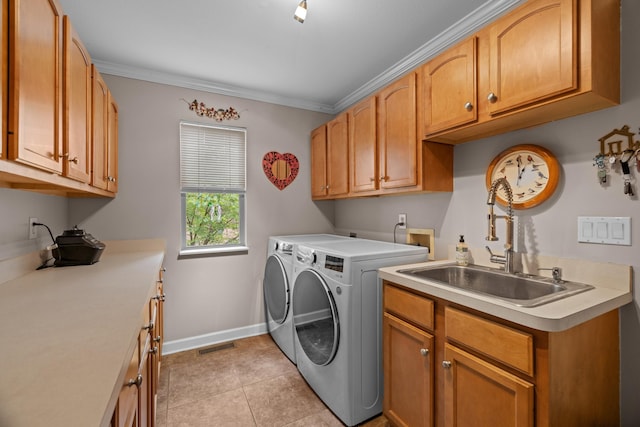 117 Tahlequah Ln, Loudon, TN 37774 - laundry room with washing machine and clothes dryer, cabinet space, baseboards, light tile patterned floors, and crown molding