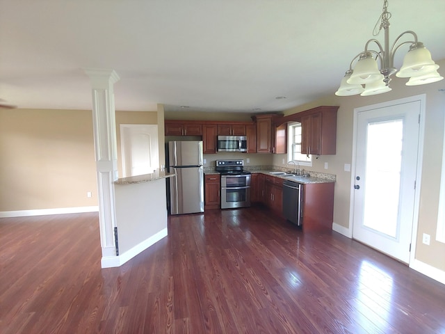 2015 Brights View Ln, Morristown, TN 37814 - kitchen with stainless steel appliances, a chandelier, dark wood finished floors, decorative light fixtures, and light stone counters