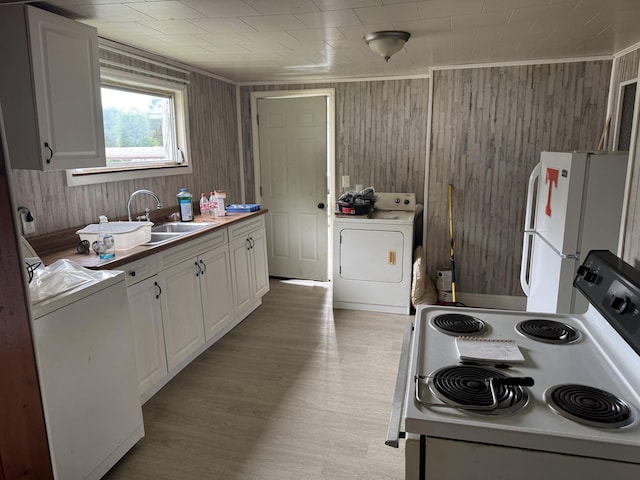 166 Clevenger Cut Off Rd, Newport, TN 37821 - kitchen featuring washer / clothes dryer, white appliances, white cabinetry, wood walls, and light wood-style flooring