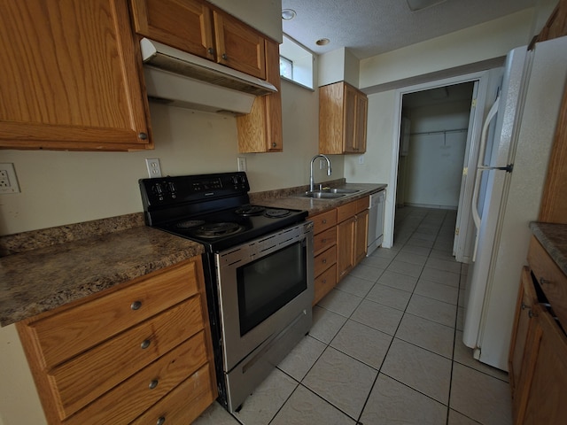 2014 Eastview Ave, Jefferson City, TN 37760 - kitchen featuring appliances with stainless steel finishes, under cabinet range hood, brown cabinets, light tile patterned floors, and a sink