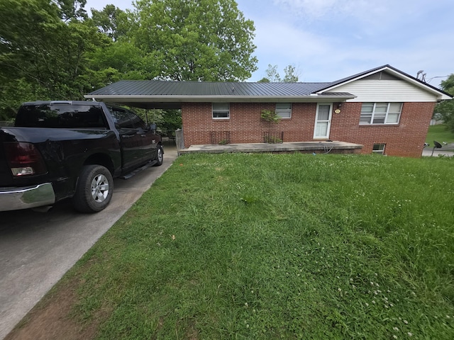 2014 Eastview Ave, Jefferson City, TN 37760 - ranch-style house with brick siding, a front yard, metal roof, a carport, and driveway