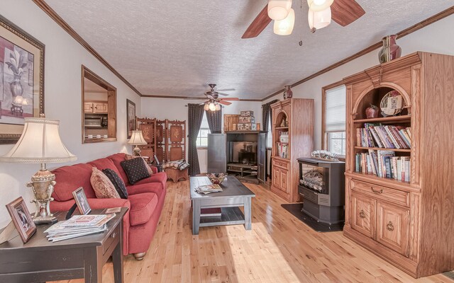 150 Florence Cir, Dandridge, TN 37725 - living room with a textured ceiling, light hardwood / wood-style floors, a wood stove, and ornamental molding