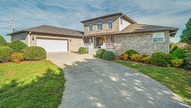 150 Florence Cir, Dandridge, TN 37725 - view of front of home with covered porch, a garage, and a front lawn
