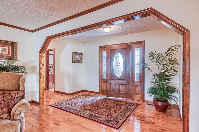 150 Florence Cir, Dandridge, TN 37725 - foyer entrance featuring light hardwood / wood-style flooring, a textured ceiling, and ornamental molding