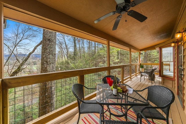 sunroom / solarium featuring vaulted ceiling and ceiling fan