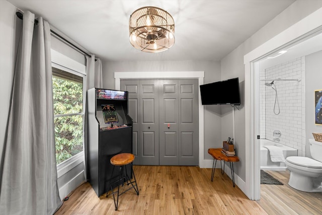 interior space with a healthy amount of sunlight, light wood-type flooring, and baseboards